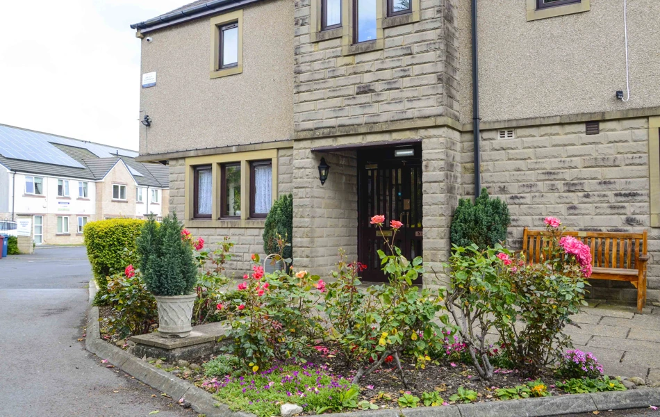 The entrance to the house with flower bed and bench at Castle View House, BB7 2DT