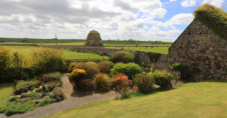 A view of the garden and countryside surrounding Armstrong House, Bamburgh