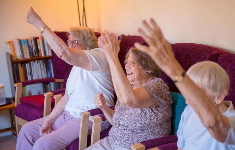 Residents enjoying some chair based exercises at Abbeyfield House