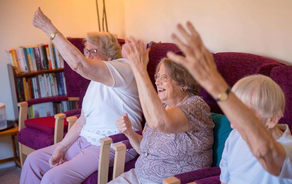 Residents enjoying some chair based exercises at Abbeyfield House