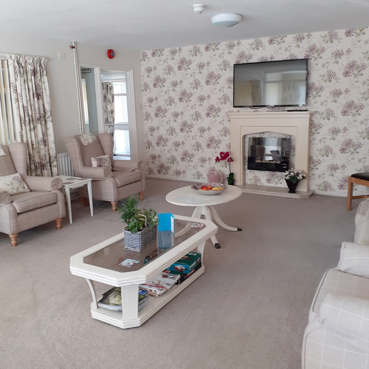 Living room with chair and TV at Tamar House