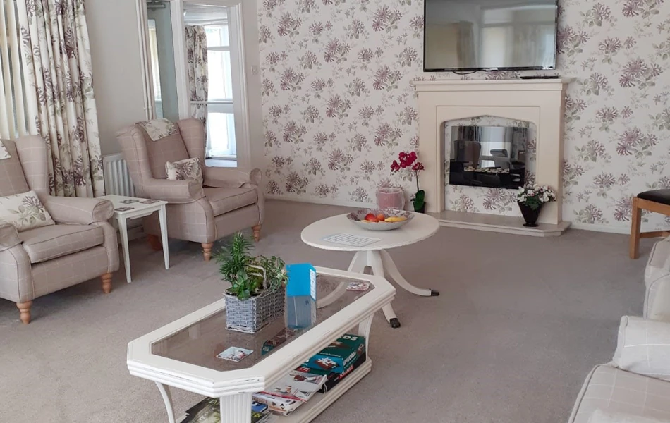 Living room with chair and TV at Tamar House