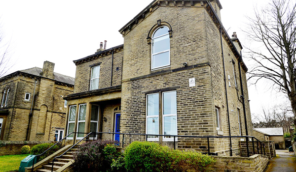 External view of Kirkview with steps to the front and shrubs in the garden
