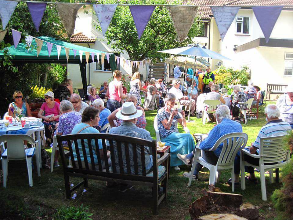 Residents, staff and families enjoying a garden party