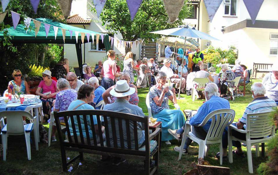 Residents, staff and families enjoying a garden party