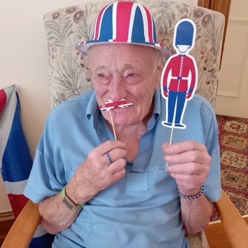 A man posing with union jack sticks