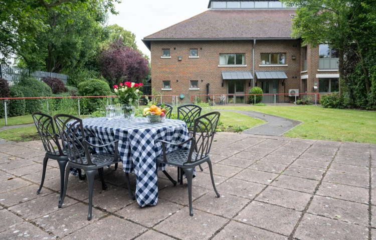 Patio with table and chairs outside Abbeyfield House, New Malden