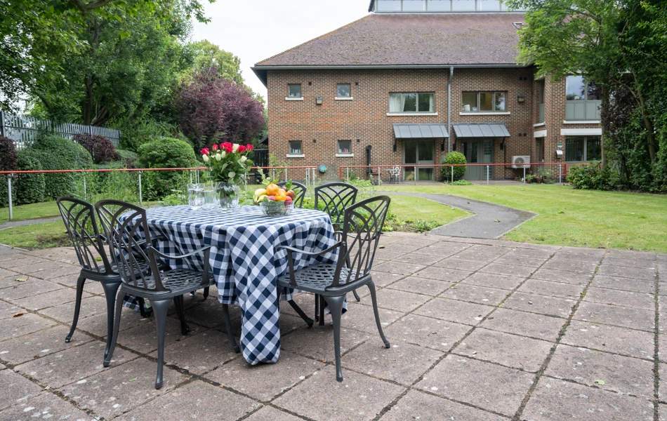 Patio with table and chairs outside Abbeyfield House, New Malden