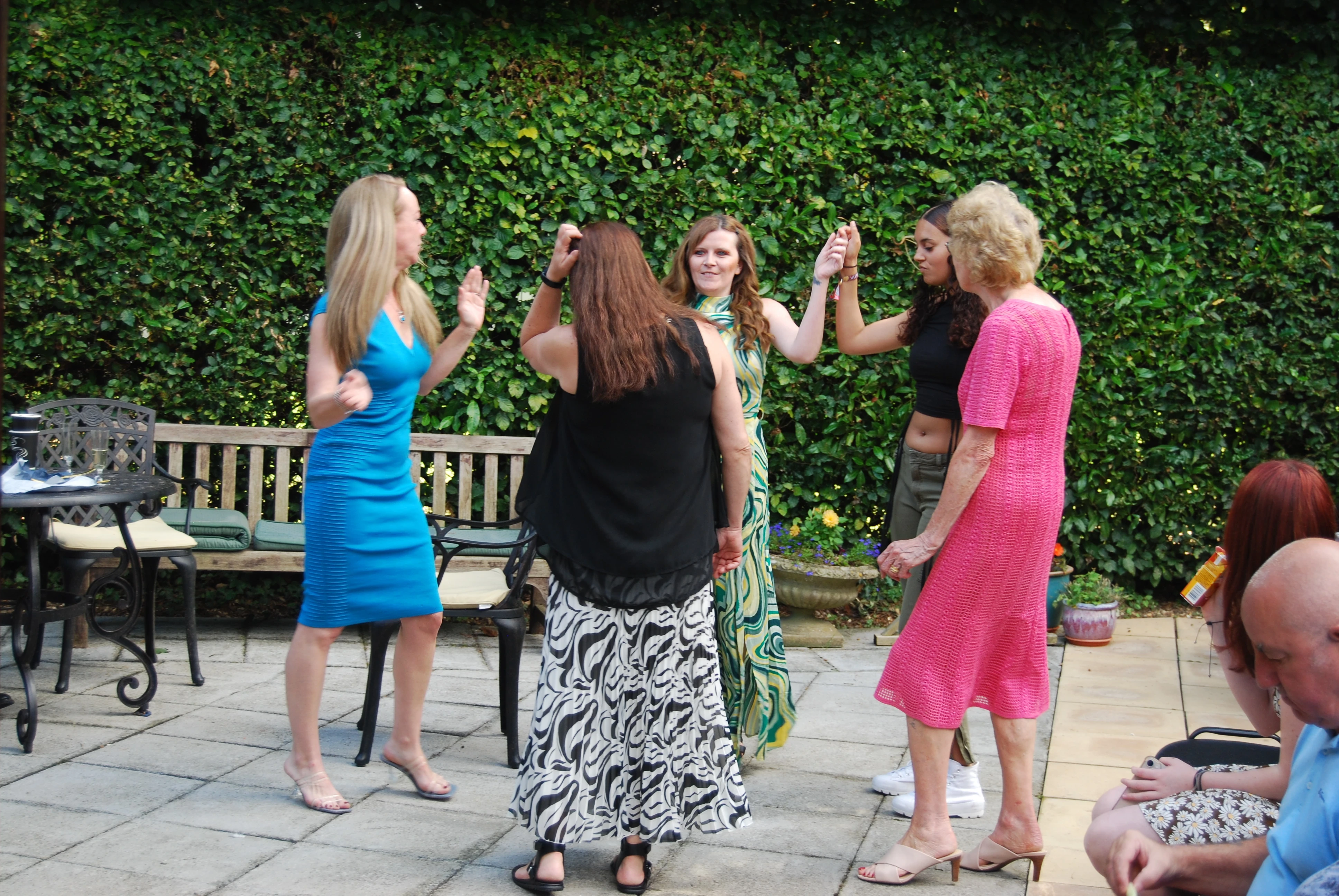 A group of women dancing on a patio