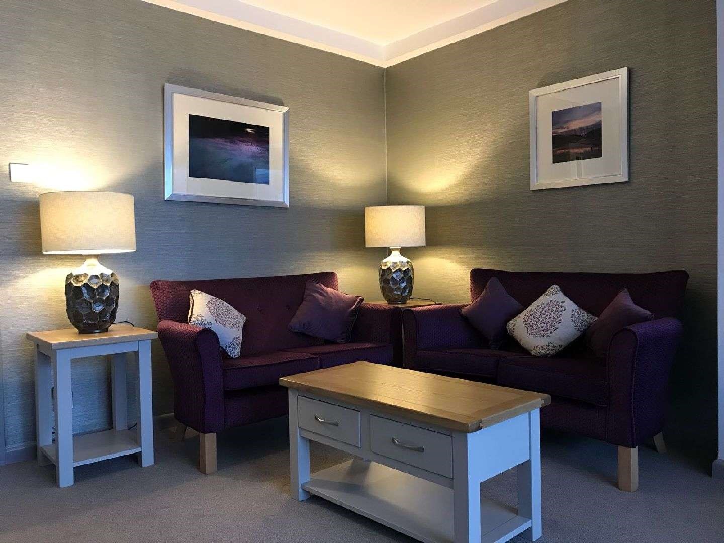 Cosy seating area with lamps and sofas