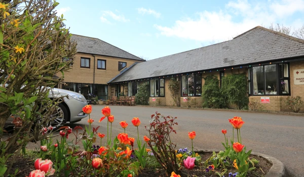 Abbeyfield House set behind a colourful flower bed