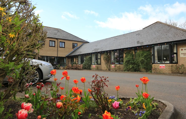 Abbeyfield House set behind a colourful flower bed