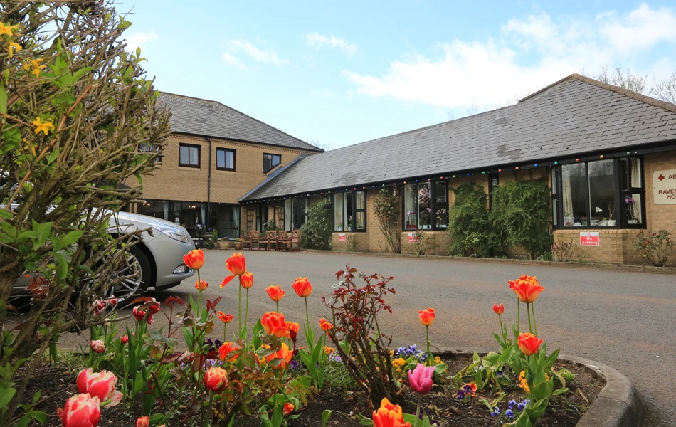 Abbeyfield House set behind a colourful flower bed
