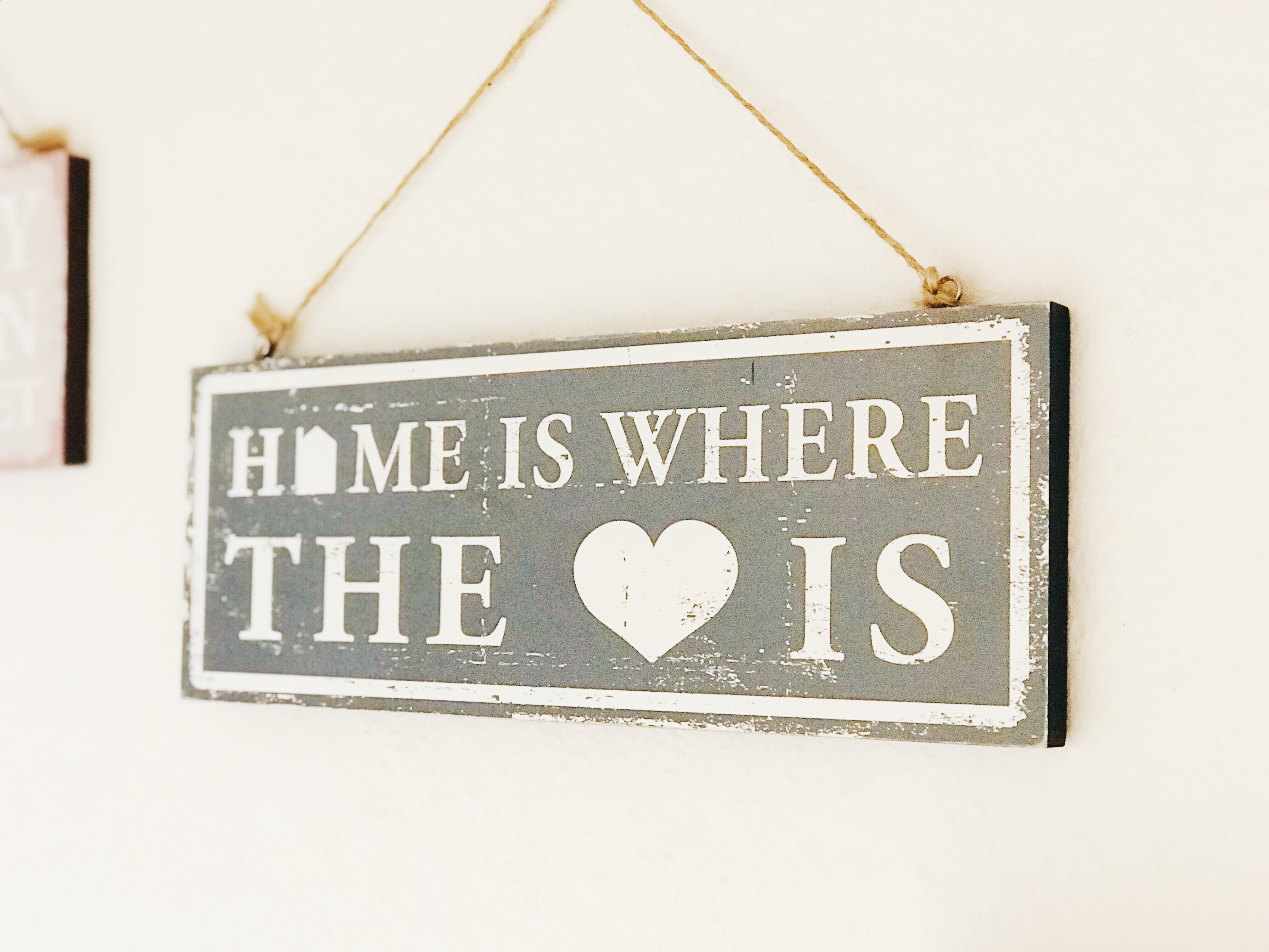 Sign on the wall saying Home is the where the heart is