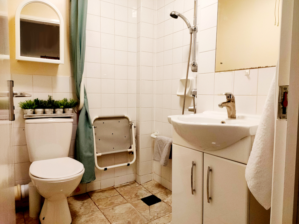 En-suite resident bathroom with wet room