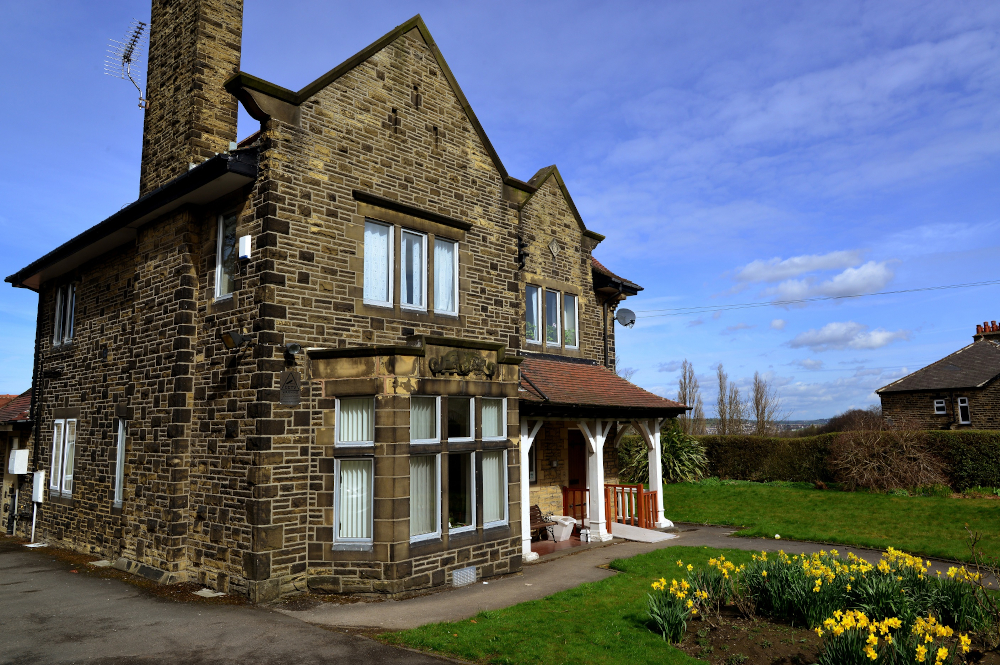 Beautiful large house with a bed of daffodils to the front of Leylands Lane, Bradford BD9 5QU