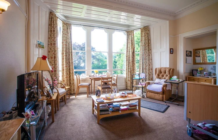 A large bedroom with tall windows at Cove House