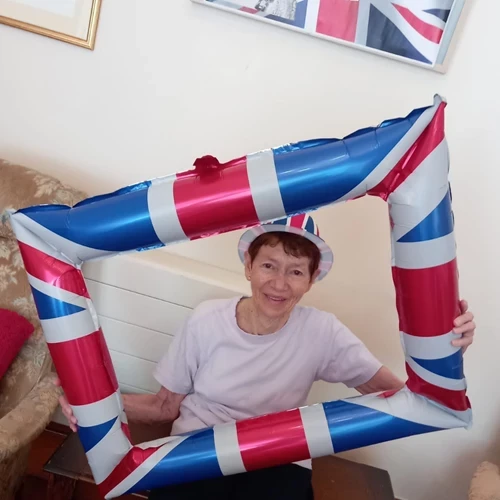 A lady posing in an inflatable union jack picture frame