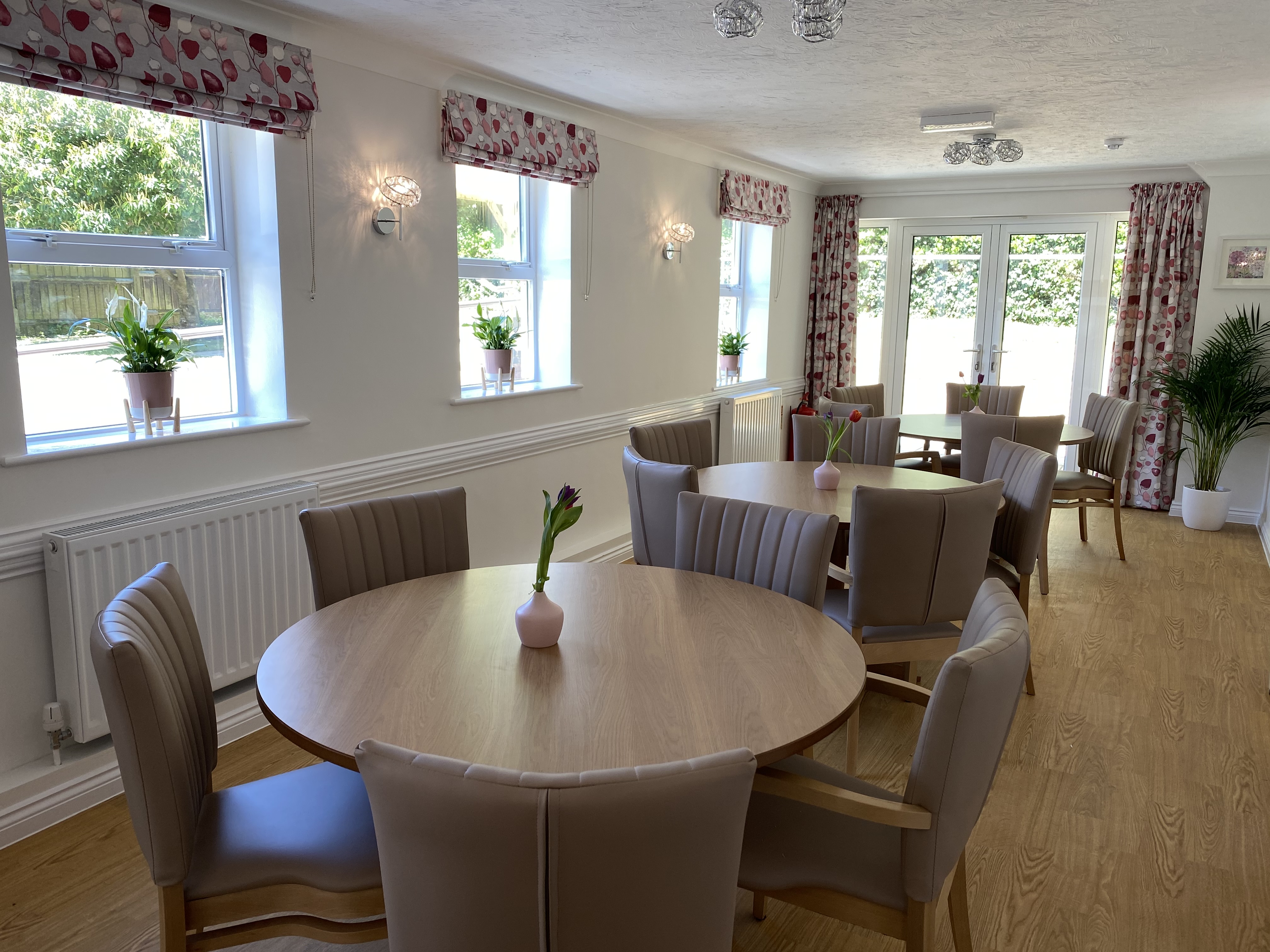A bright modern dining area with ample seating for residents
