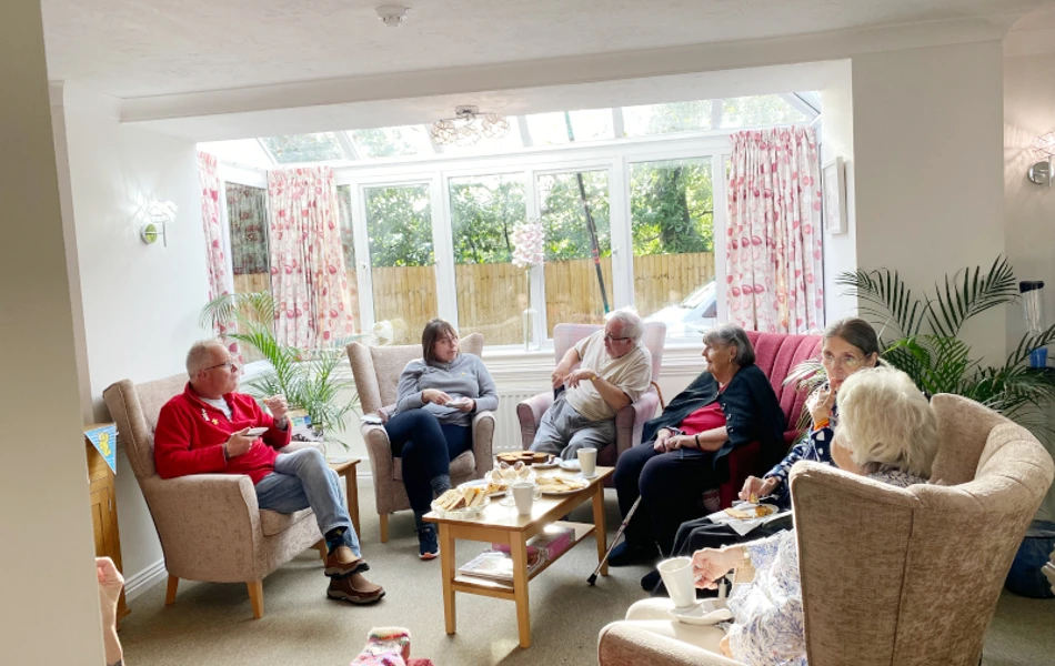Harleston House Residents Enjoy Spending Time Together Socialising In The Communal Lounge