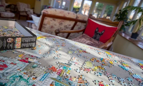 A part completed puzzle on a table