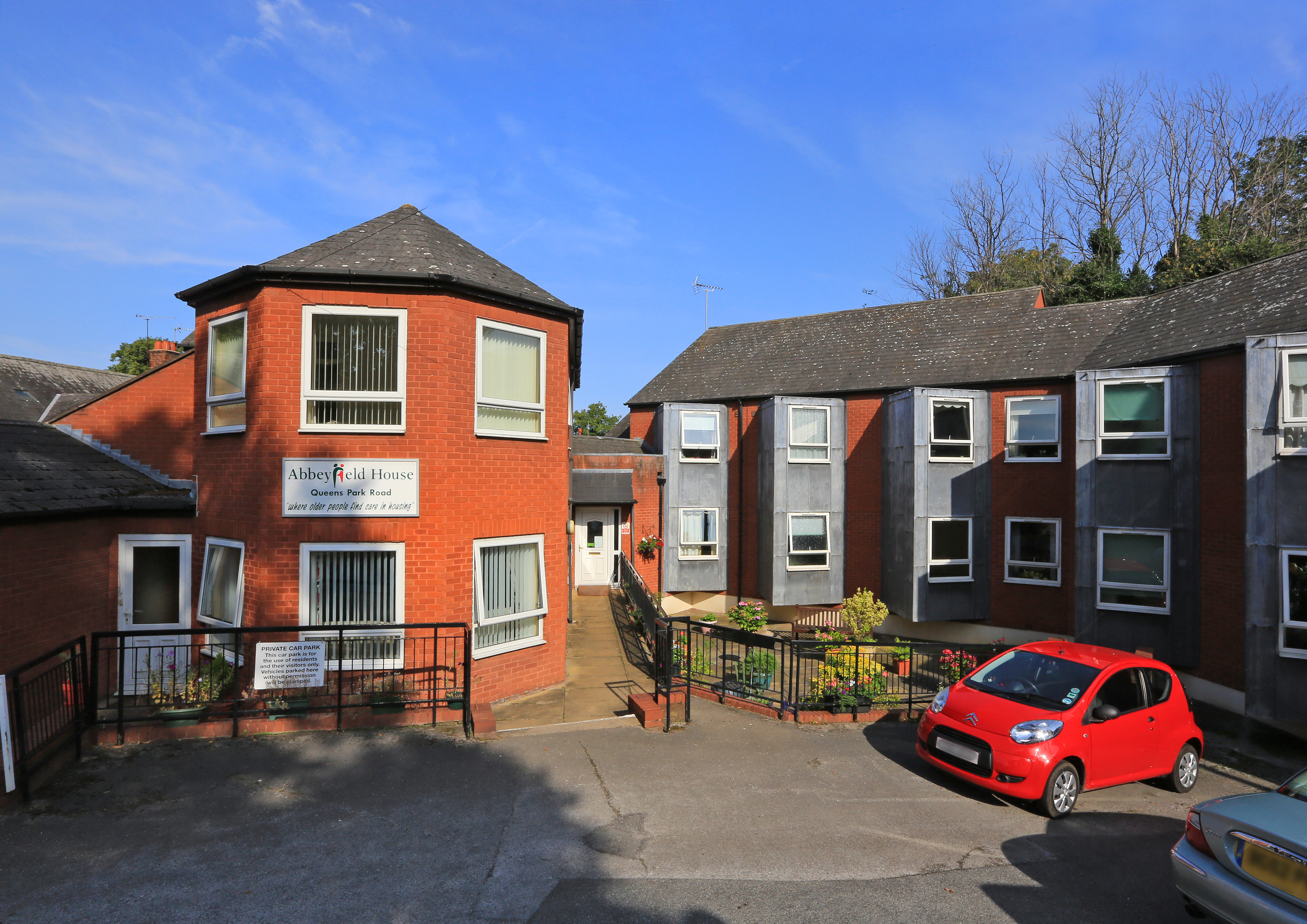 The front of the house with parking outside Abbeyfield House