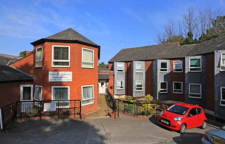 The front of the house with parking outside Abbeyfield House