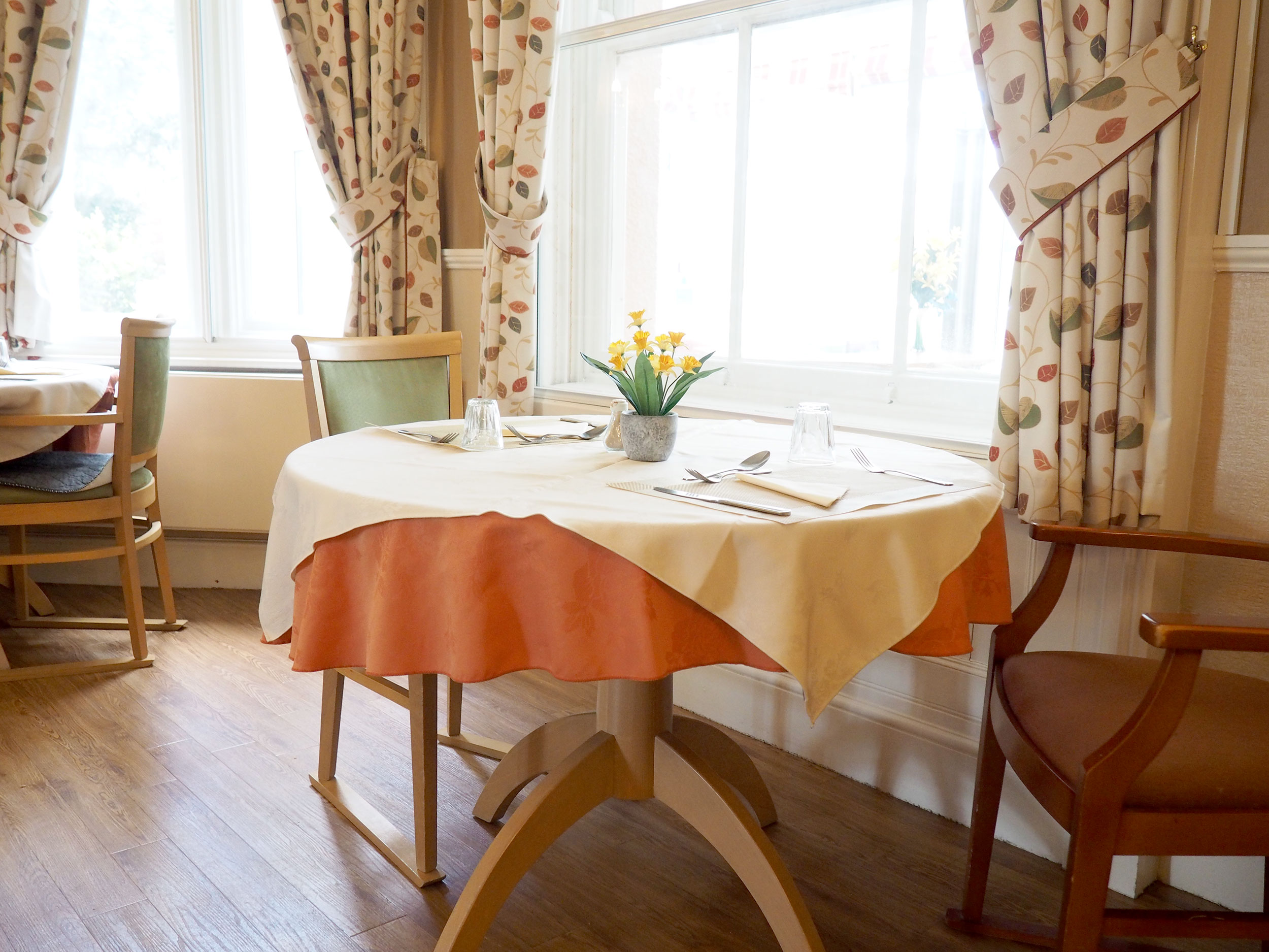 Dining room table by window at Hill House, Honiton