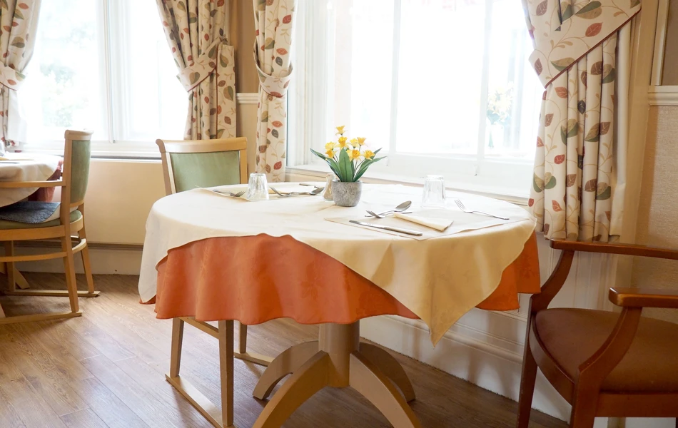 Dining room table by window at Hill House, Honiton