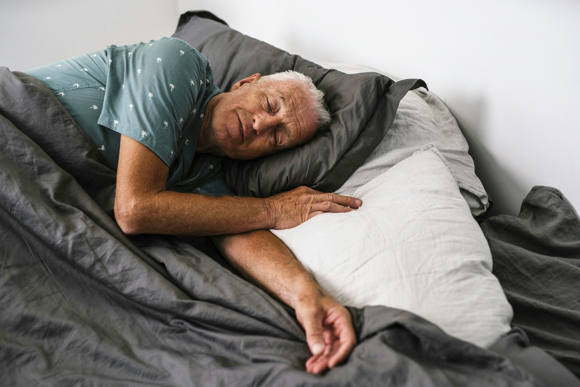 Older Man Asleep In Bed