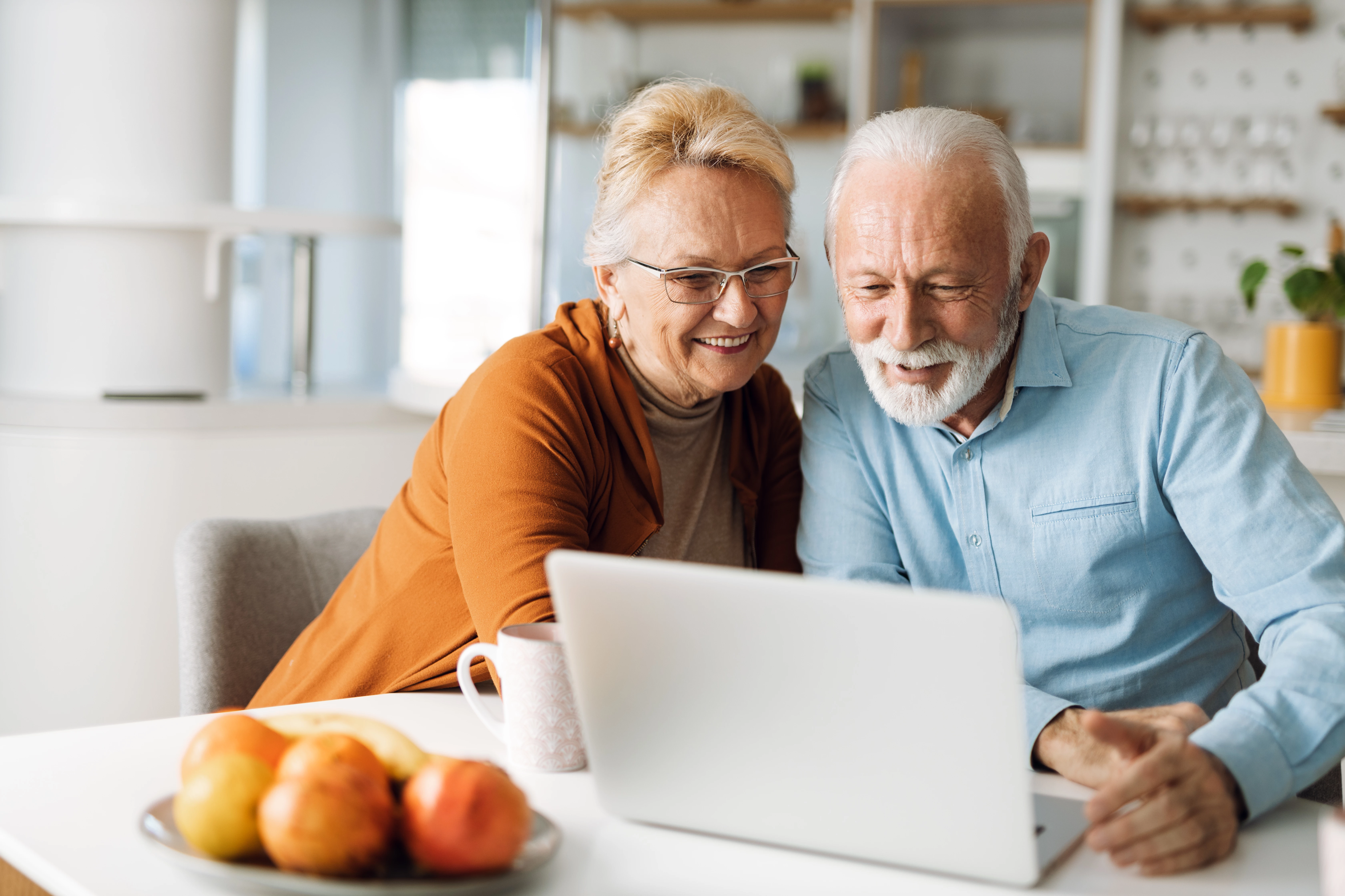 Older Couple Looking At Laptop