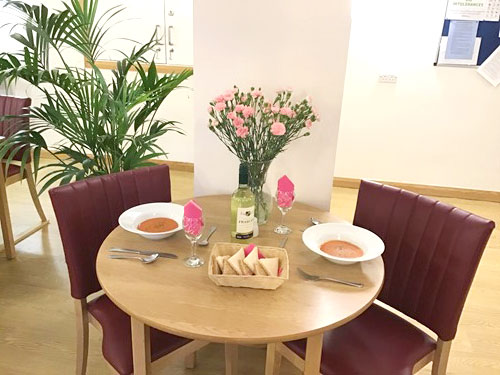 Table and chairs with meal on the table at Westbourne House