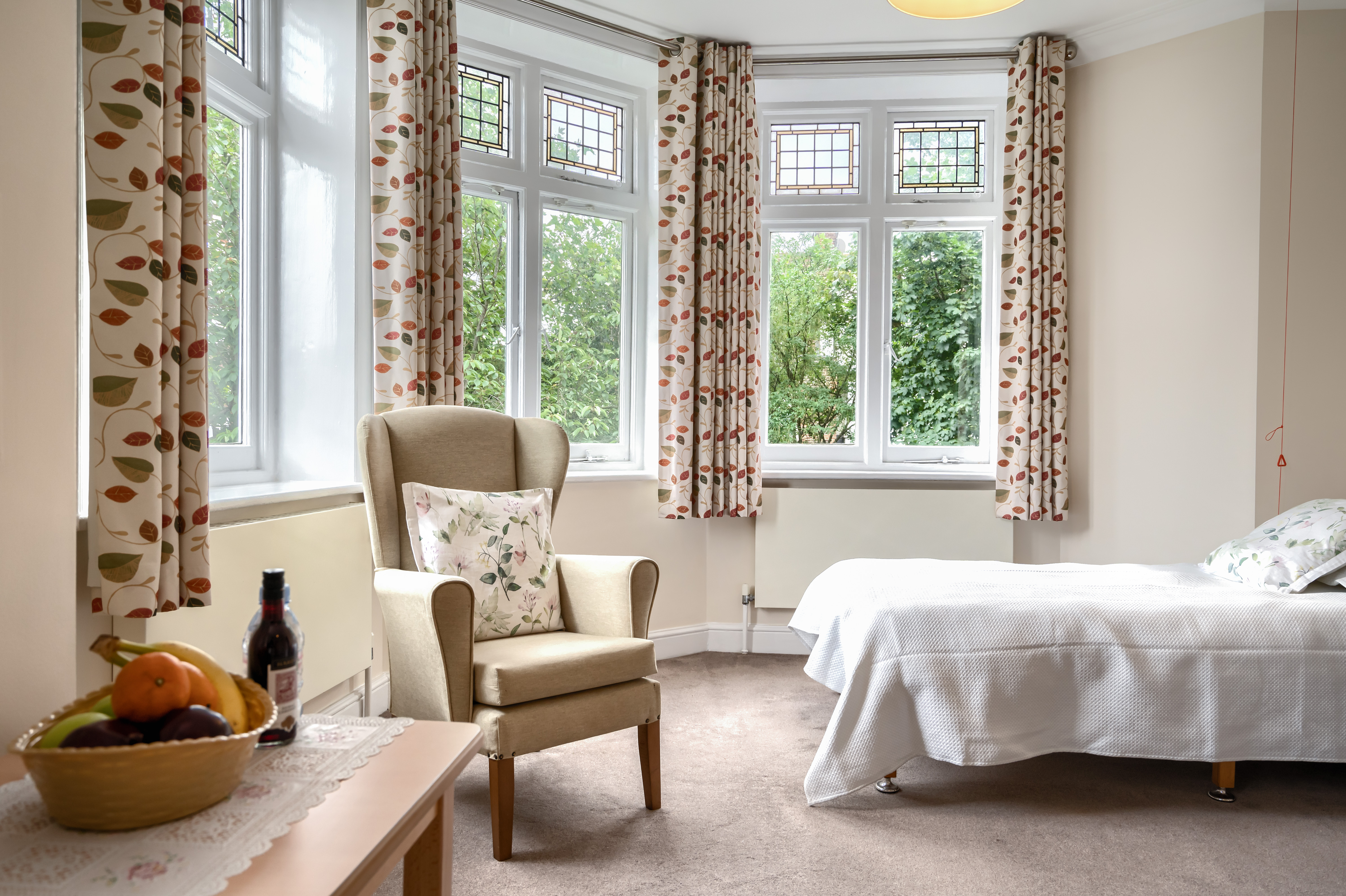 Bedroom with garden view through bay windows at Lee House Wimbledon