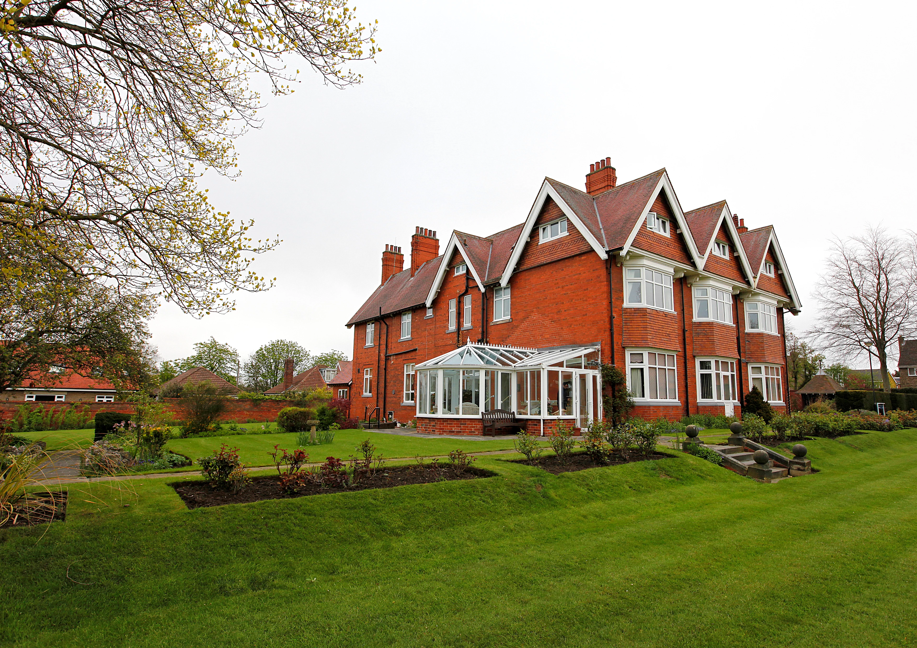Large Red Bricked House With A Conservatory And Large Garden