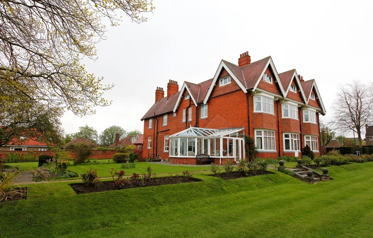 Large Red Bricked House With A Conservatory And Large Garden