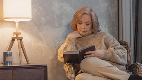 lady sitting on a chair reading a book