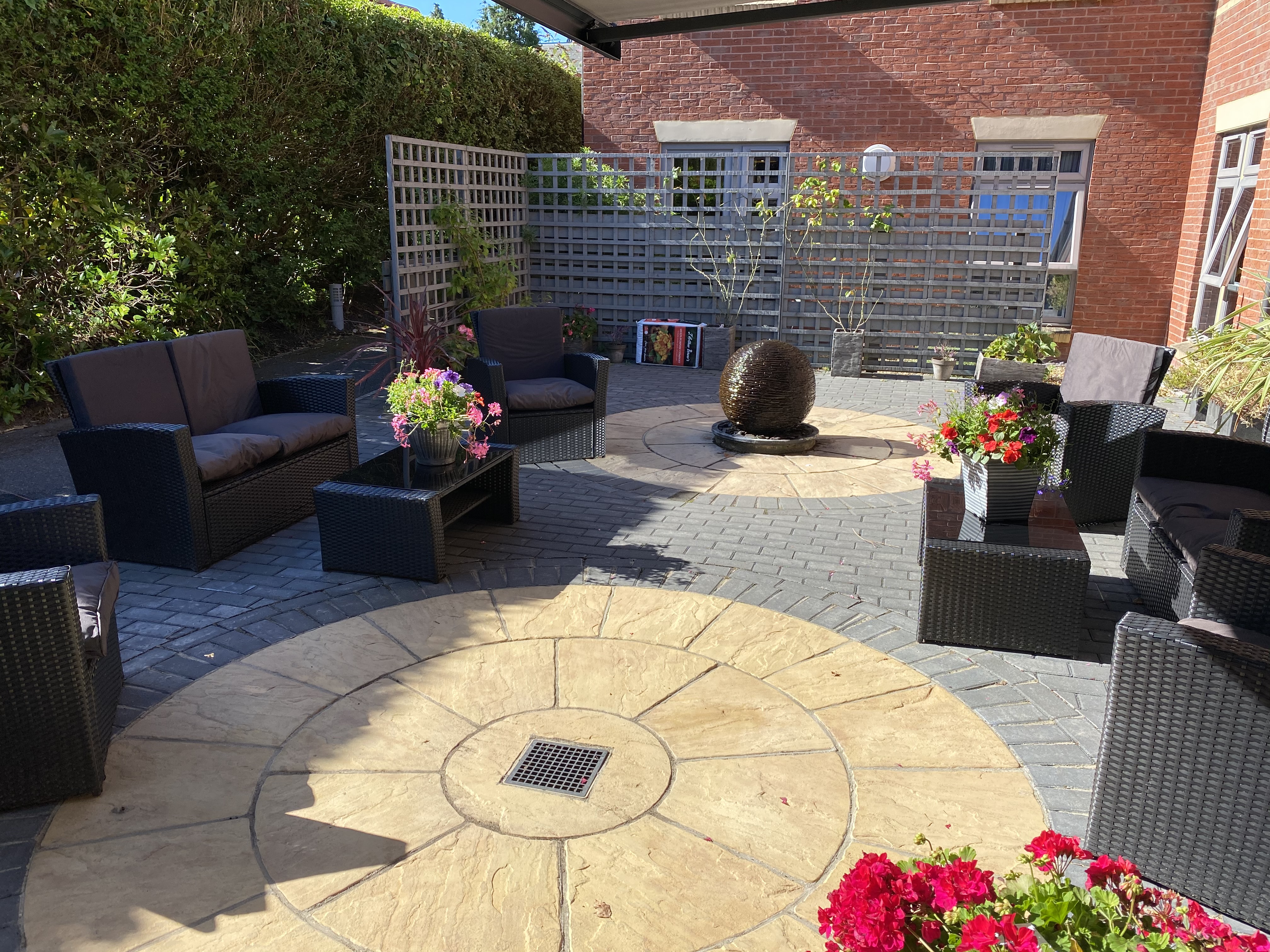 Courtyard with garden chairs, plants and table at Westbourne House