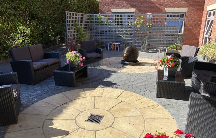 Courtyard with garden chairs, plants and table at Westbourne House