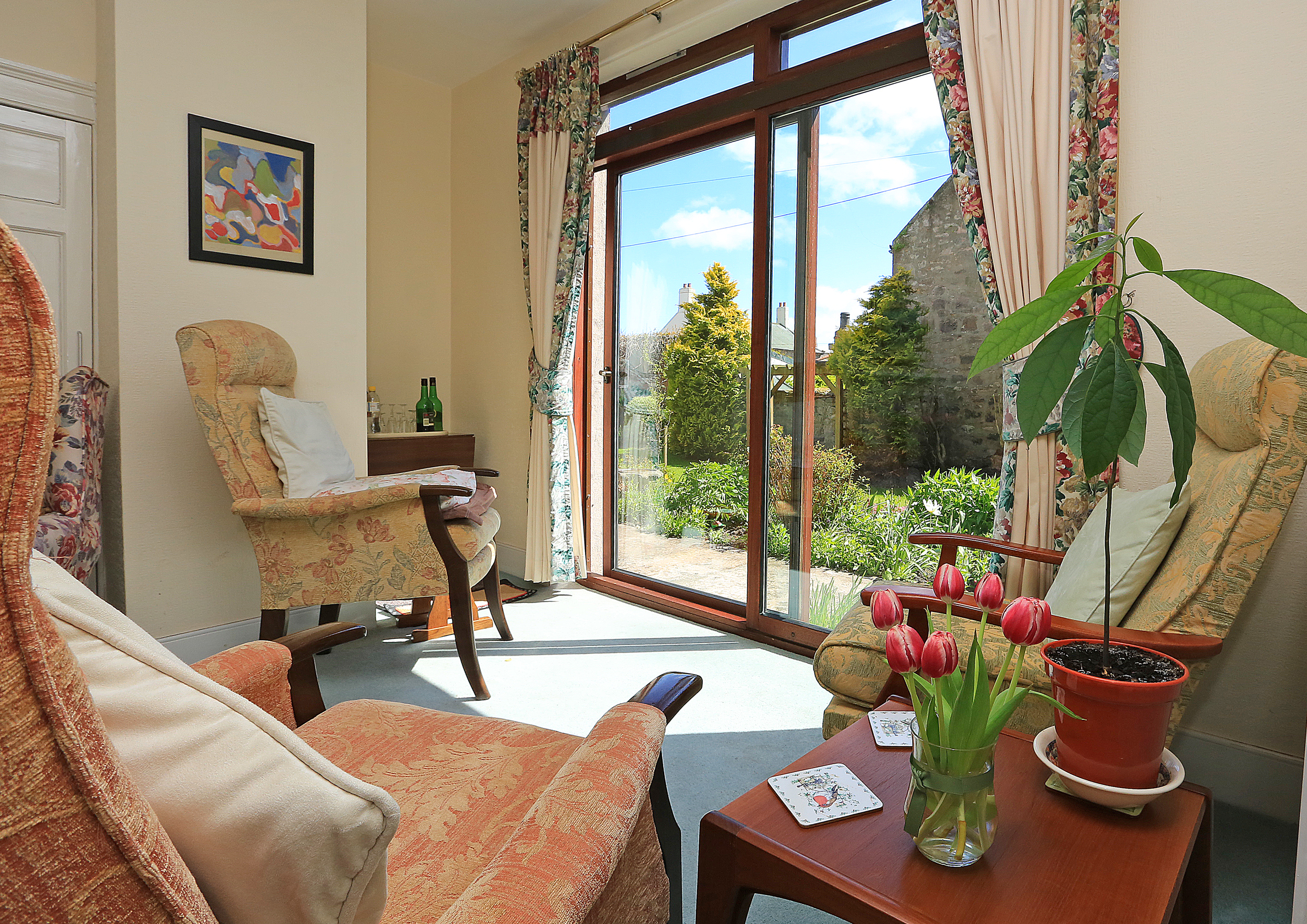 A bright lounge area with beautiful views into the garden