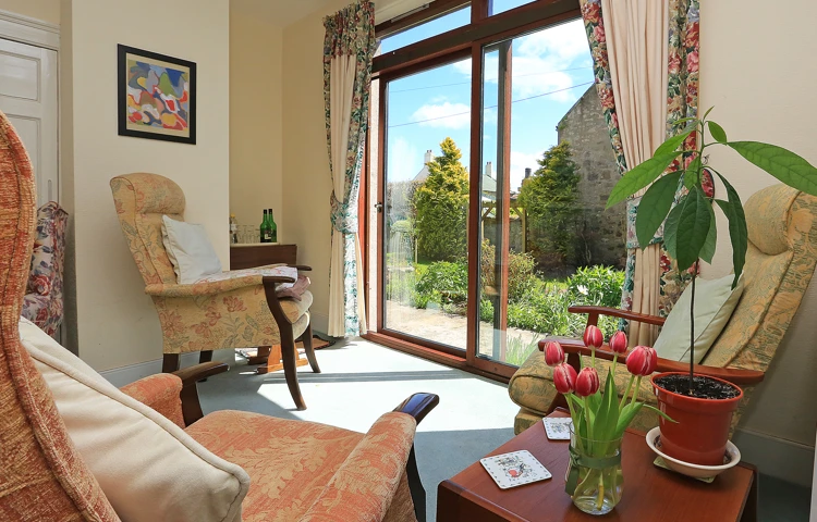 A bright lounge area with beautiful views into the garden