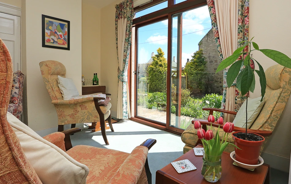 A bright lounge area with beautiful views into the garden