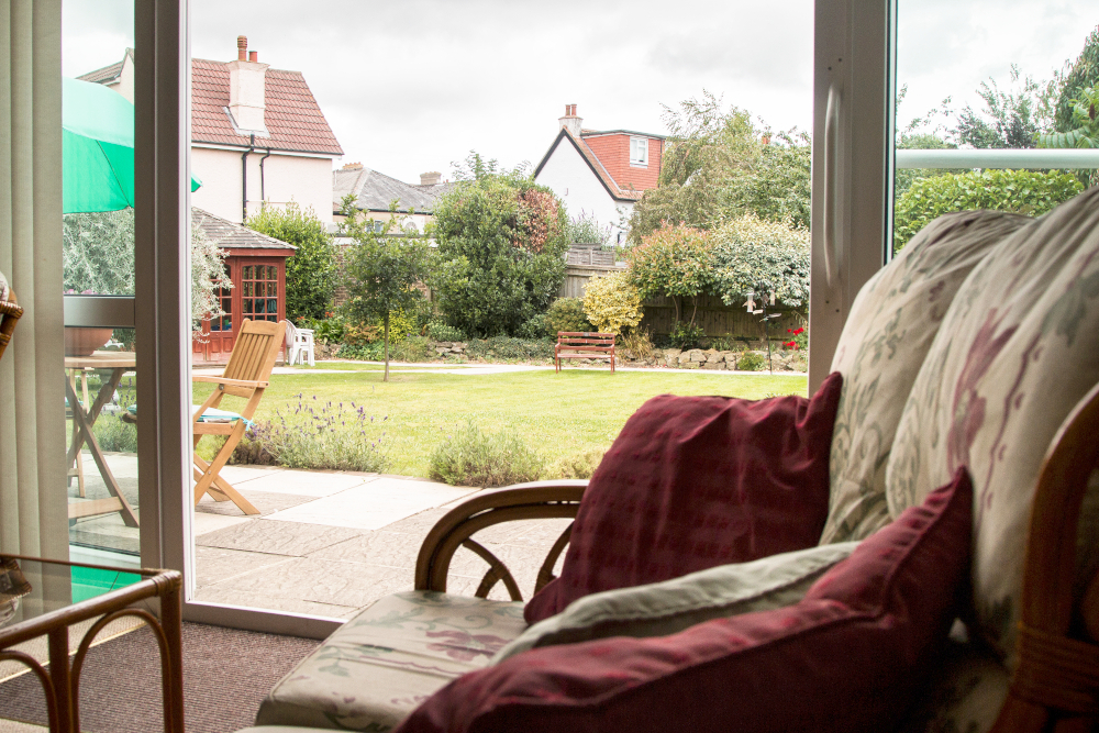 Lounge area overlooking the beautiful sunny garden at Oakshade