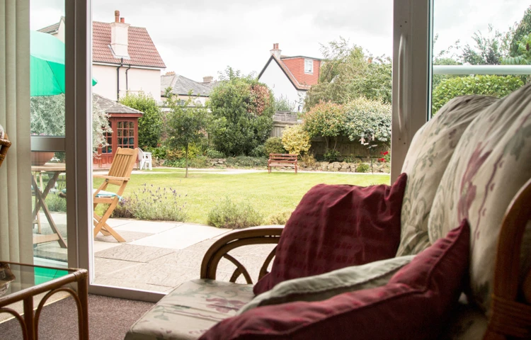 Lounge area overlooking the beautiful sunny garden at Oakshade