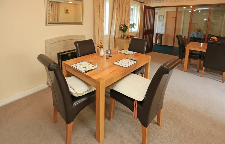 A modern dining table with leather chairs