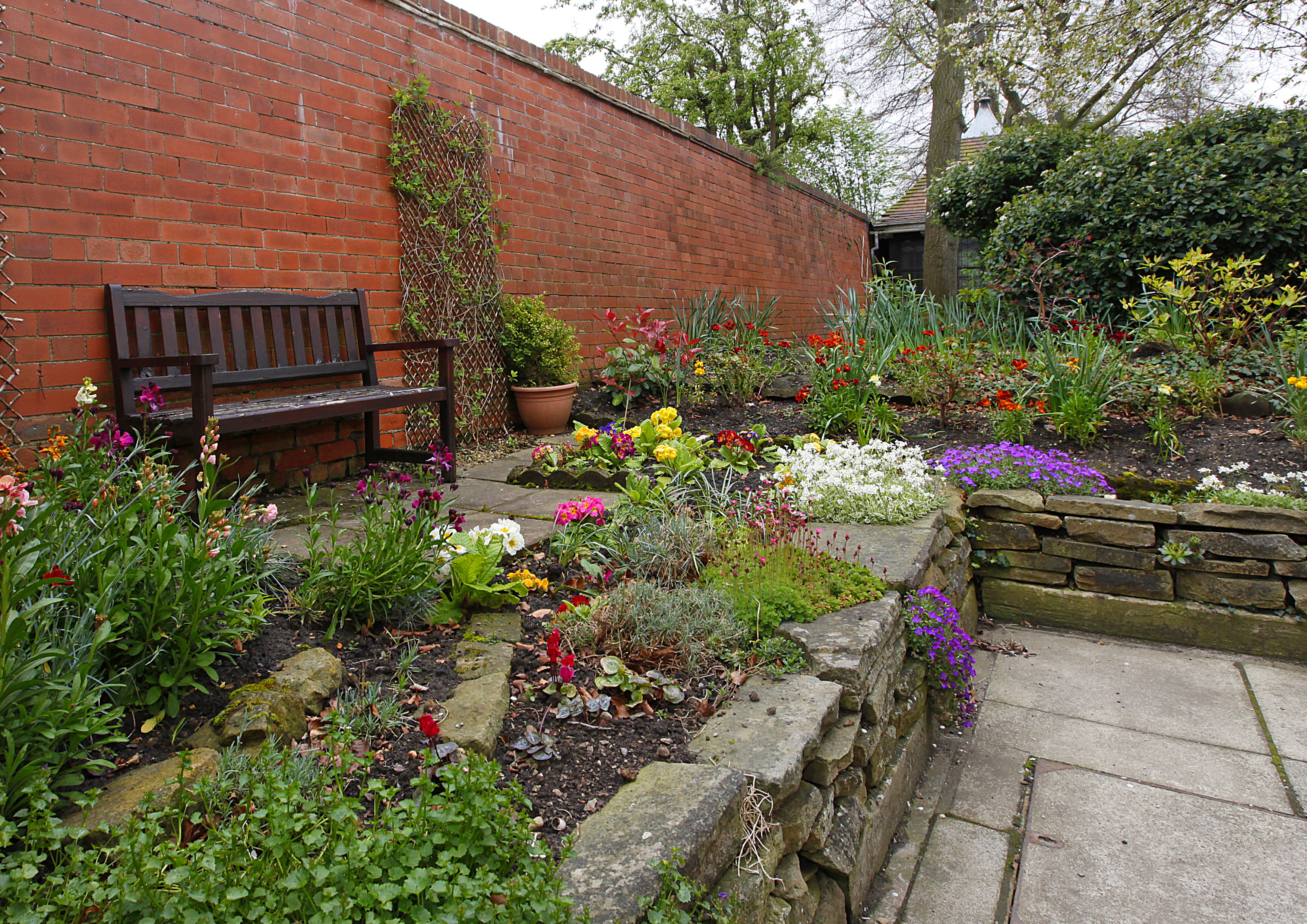 Raised beds in the garden with a bench in the garden at Earl Keelan House DL3 8PD