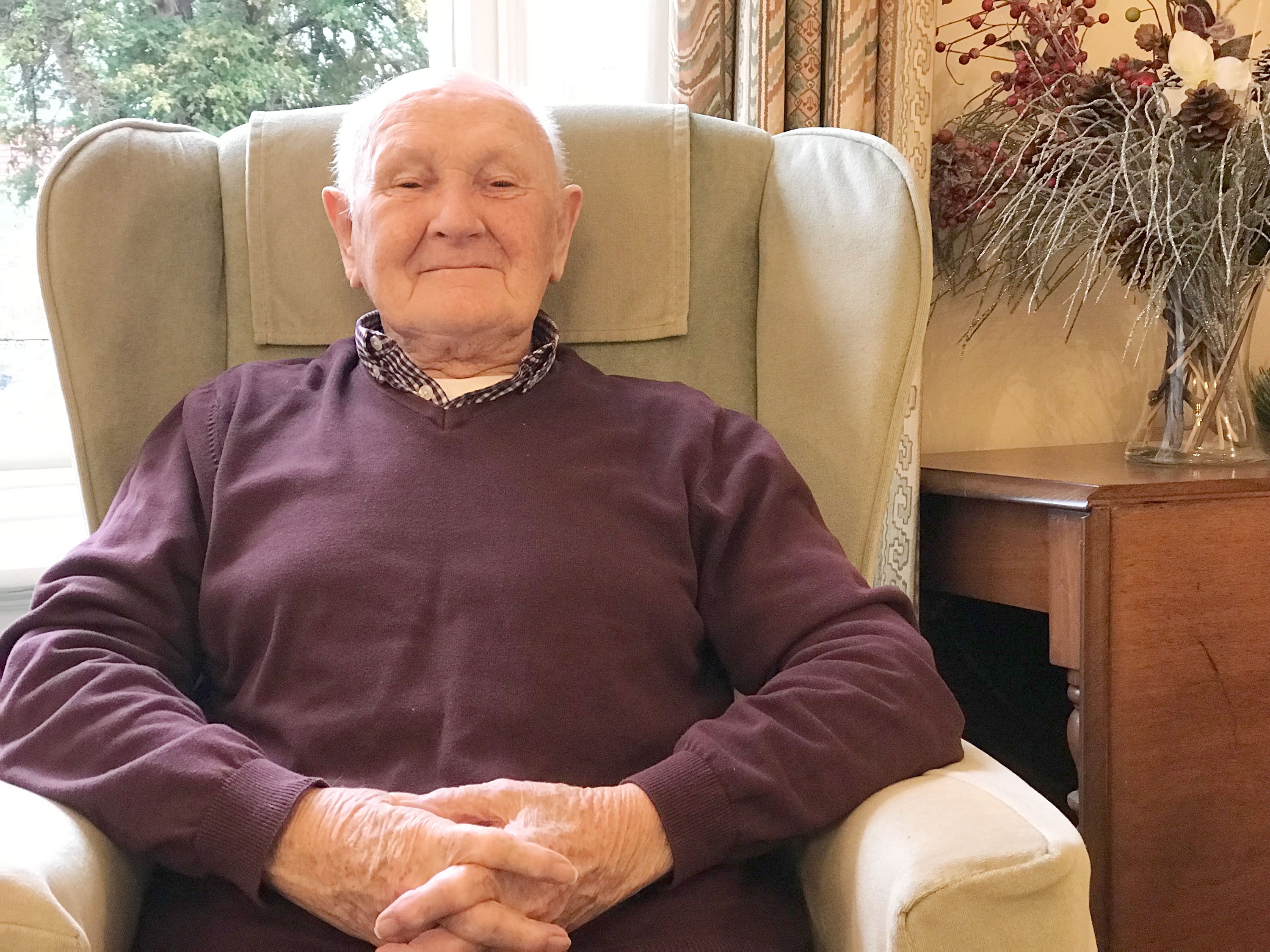 Resident sitting in a chair at Prestbury House, Cheltenham GL52 3DD