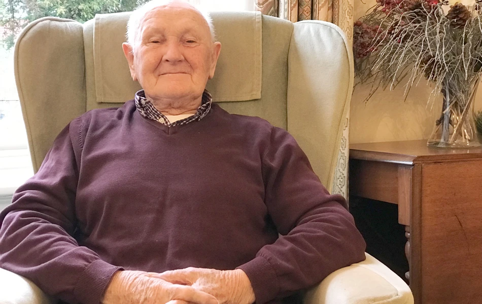 Resident sitting in a chair at Prestbury House, Cheltenham GL52 3DD