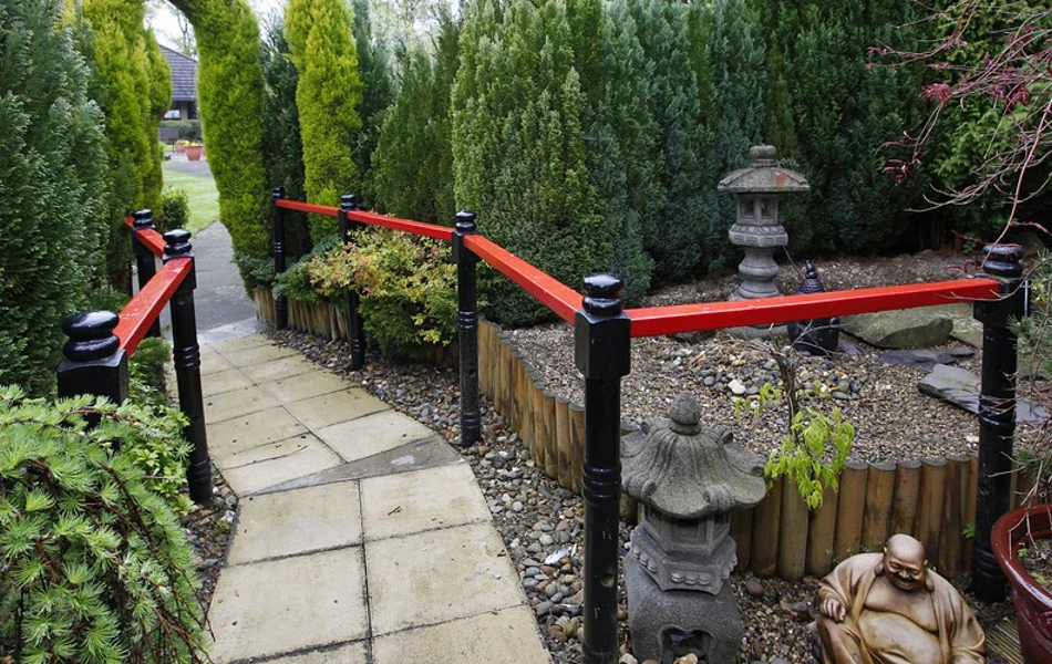 A pathway through the garden with ornaments