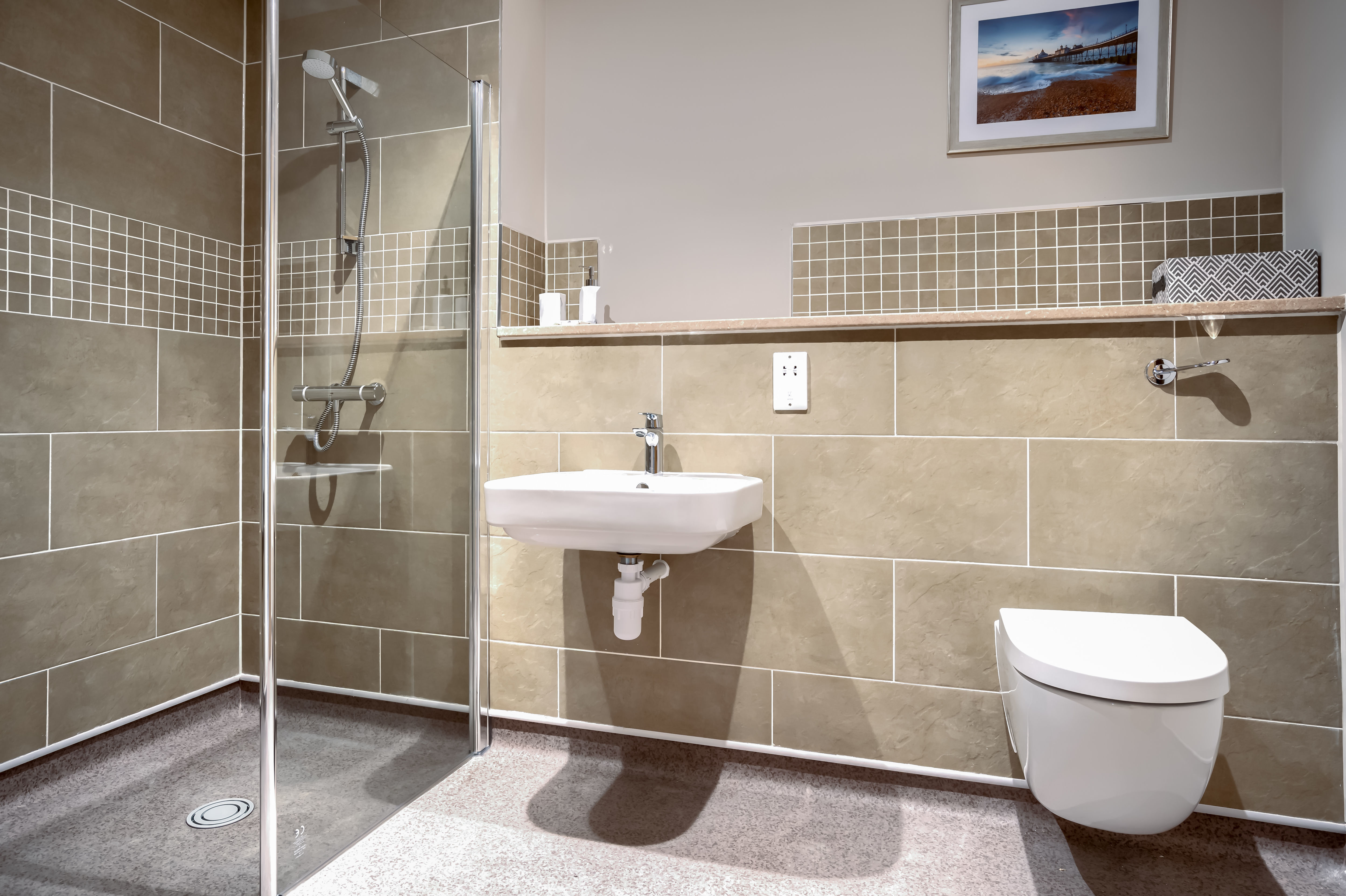 A fully tiled bathroom with walk in shower and modern features