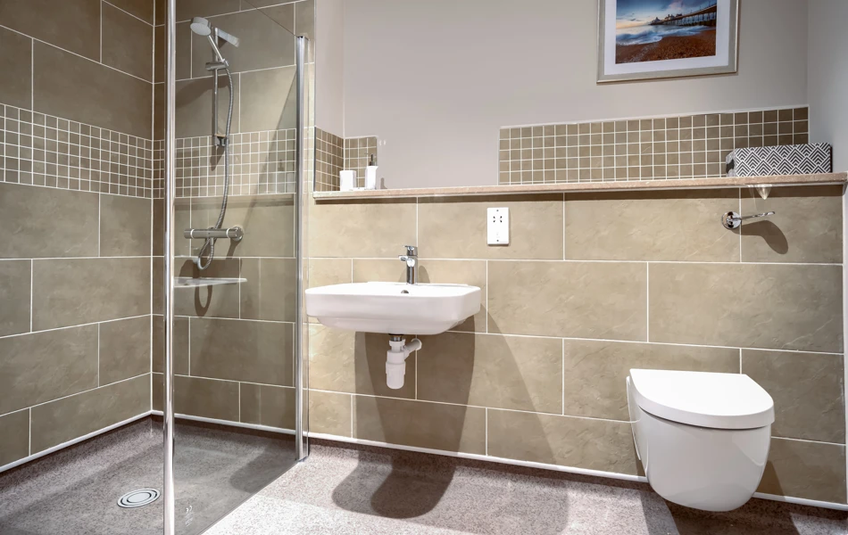 A fully tiled bathroom with walk in shower and modern features